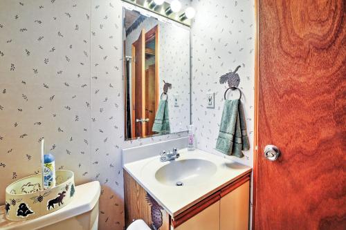 a bathroom with a sink and a mirror at Peaceful Lincoln Chalet Less Than 2 Mi to Loon Mtn Skiing! in Lincoln