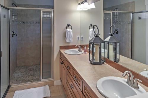 a bathroom with two sinks and a shower at Gorgeous Wapato Point Lakehouse with Private Hot Tub in Manson