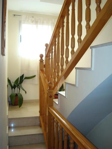 a stairway with a wooden railing and a stair case at Casa Pili in Los Cerezos
