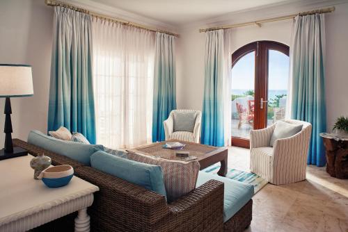 a living room with a couch and chairs and a table at La Samanna, A Belmond Hotel, St Martin in Baie Longue