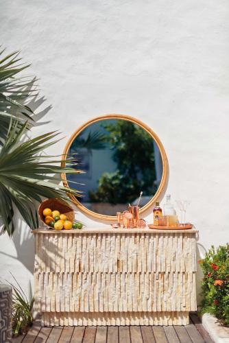 a mirror on top of a wicker basket with a sink at La Samanna, A Belmond Hotel, St Martin in Baie Longue