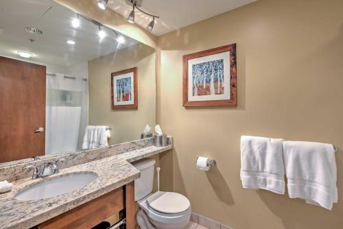a bathroom with a sink and a toilet and a mirror at Ski-InandSki-Out Studio at Sundial Lodge with Hot Tub! in Park City