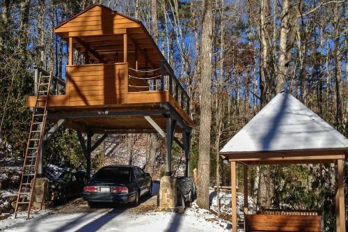 a tree house with a car parked under it at Highlands Cabin with Forest Views Less Than 4 Mi to Cashiers in Highlands