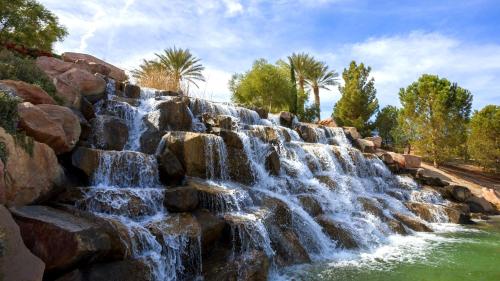a waterfall in a park with rocks and trees at Lake Las Vegas Condo with Balcony, Resort Amenities! in Henderson