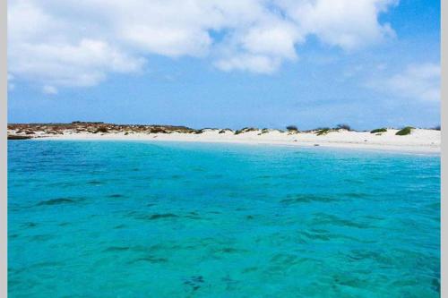a beach with turquoise water and a white beach at Kasa Mona in Calheta Do Maio
