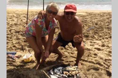 a man and a woman on the beach at Kasa Mona in Calheta Do Maio