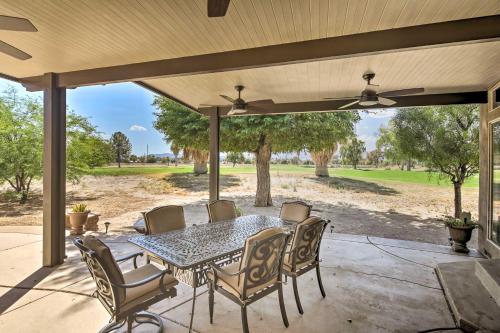 an outdoor patio with a table and chairs at Rivers Edge Golf Condo with Beach Access and Patio! in Needles