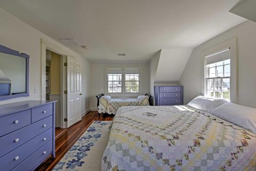 a bedroom with a bed and a dresser and windows at Bright Chatham House Less Than half Mi to Lighthouse Beach! in Chatham