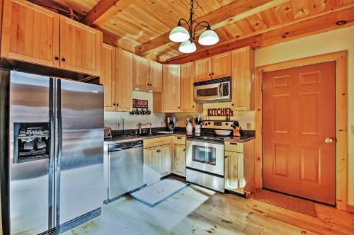 a kitchen with wooden cabinets and a stainless steel refrigerator at Luna Stella - West Dover Home 1 Mi to Mt Snow! in West Dover