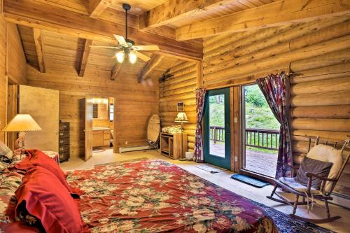 a bedroom in a log cabin with a bed and a window at Bear View Lodge in Alma 15 Mi to Breckenridge! in Alma