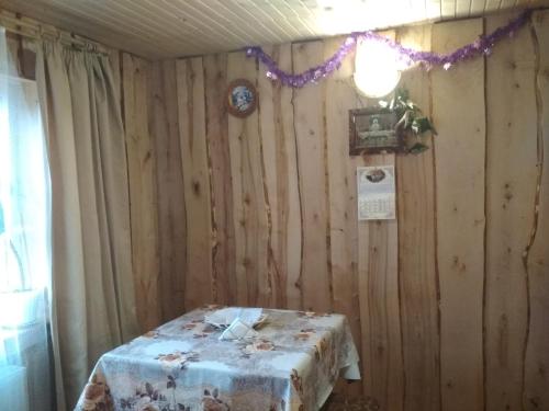 a table in a room with a wooden wall at Na Horbyku in Tatariv