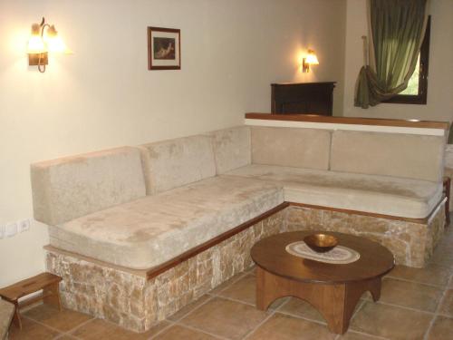a living room with a couch and a table at Village Naiades in Kastoria