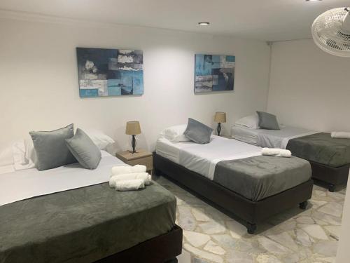 Ліжко або ліжка в номері HOTEL BELEN-La Flora- Cali Valle del Cauca
