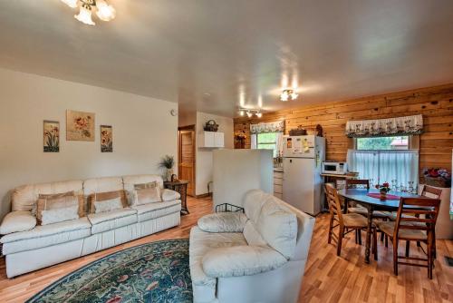 a living room with a white couch and a table at Cozy Colorado Cabin with Deck, Grill and River Access! in Buena Vista