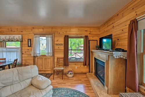 a living room with a couch and a fireplace at Cozy Colorado Cabin with Deck, Grill and River Access! in Buena Vista