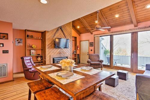 a living room with a wooden table and a tv at All-Season Base in Beech Mountain, Pets Welcome! in Beech Mountain