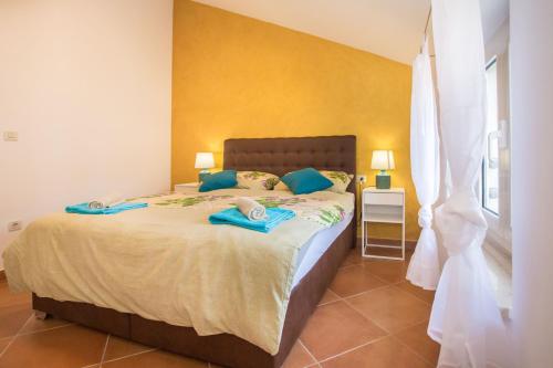 a bedroom with a large bed with blue towels on it at KALA Main Square Poreč in Poreč
