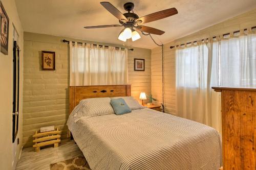 a bedroom with a bed with a ceiling fan at Renovated Tucson Gomez Casita with Yard Less Than 7 Mi to DT in Tucson