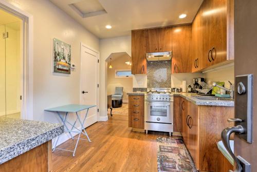 a kitchen with wooden cabinets and a stove top oven at Updated Menlo Park English Tudor Garden Cottage! in Menlo Park