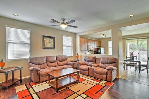 a living room with two couches and a table at Dog-Friendly Retreat with Patio and Yard in Gilbert! in Gilbert