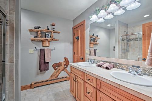 a bathroom with two sinks and a large mirror at Granby House with Deck, Mtn View - 2 Mi from Skiing! in Granby