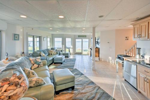 a large living room with couches and a kitchen at Luxurious Oceanfront Flanders Bay Home with Kayaks! in Sullivan