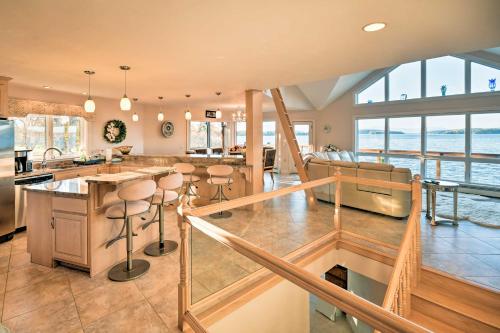a kitchen and living room with a view of the ocean at Luxurious Oceanfront Flanders Bay Home with Kayaks! in Sullivan