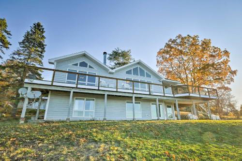 a large house on top of a hill at Luxurious Oceanfront Flanders Bay Home with Kayaks! in Sullivan