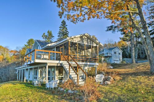 a home with a large glass house on a hill at Luxurious Oceanfront Flanders Bay Home with Kayaks! in Sullivan
