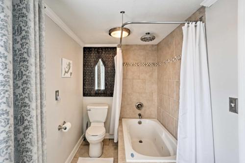 a bathroom with a toilet and a bath tub at Waterfront Oak Harbor Home on Lake Erie with Views! in Sand Beach
