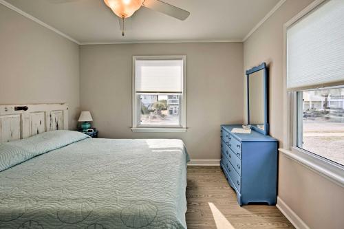 a bedroom with a bed and a blue dresser and a window at Holden Beach Vacation Rental Steps to Shore! in Holden Beach