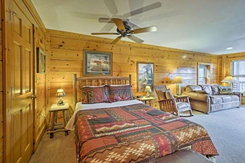 a bedroom with a bed and a couch at Pigeon Forge Resort Studio Cabin on Dollywood Ln! in Pigeon Forge