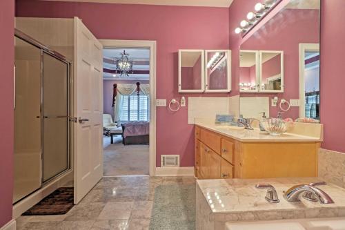 a bathroom with pink walls and a shower and a sink at Stunning Duluth Family House with Fireplace and Patio! in Duluth