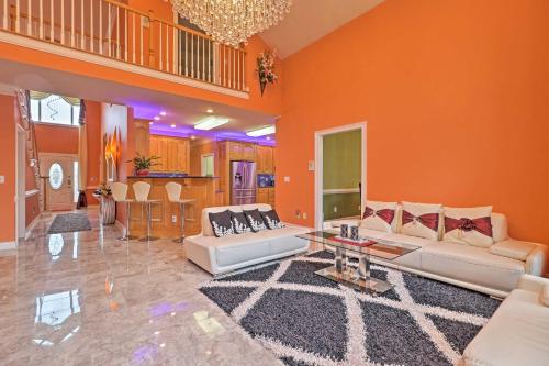 a living room with orange walls and white couches at Stunning Duluth Family House with Fireplace and Patio! in Duluth