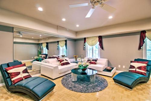 a living room with white furniture and a ceiling fan at Stunning Duluth Family House with Fireplace and Patio! in Duluth