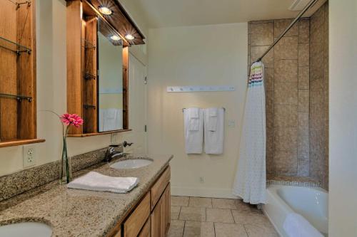 a bathroom with two sinks and a bath tub and a sink at Casa dAmore Extravagant Lakefront Villa! in Granite Bay