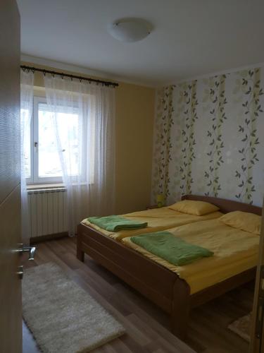 a bedroom with a bed and a window at Apartment Zabljak Center in Žabljak