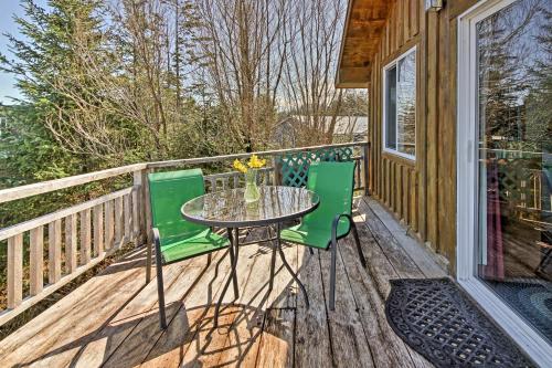 a patio with a table and chairs on a deck at A Room with a View Peaceful Retreat on PoW in Coffman Cove