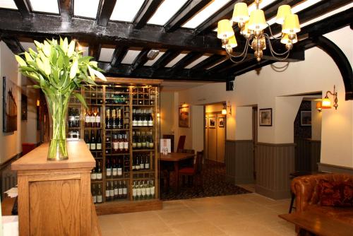 a room with a vase of flowers on a table at The Bear Hotel by Greene King Inns in Hungerford