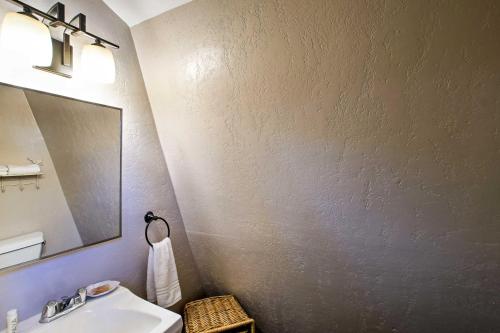 a bathroom with a sink and a mirror at Spacious Cabin with Deck, Mountain Views, Fire Pit! in Prescott