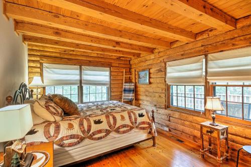 a bedroom with a bed in a log cabin at Family-Friendly Massanutten Log Home with Views! in McGaheysville