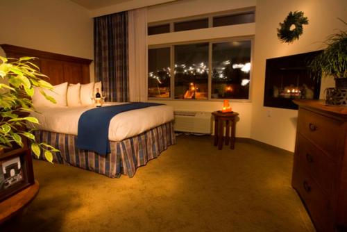 a bedroom with a bed and a window with a view at The Rockwell Inn in Jackson