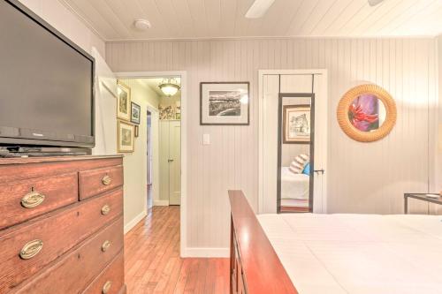 a living room with a television and a dresser with a tv at Redwoods Cabin with Hot Tub Walk to Russian River! in Guerneville