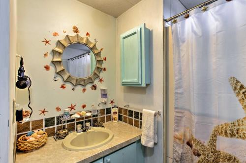 a bathroom with a sink and a mirror at Walk to Beach! The Little Orcas Moclips Cottage in Moclips