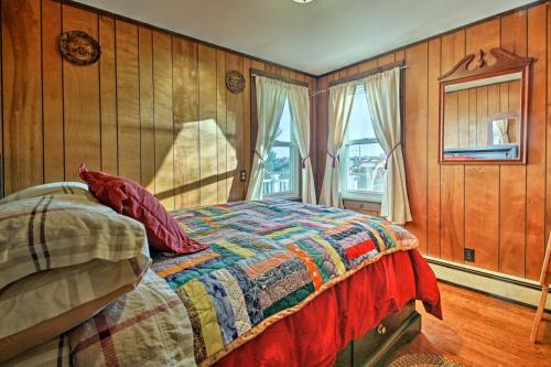una camera da letto con un letto con una trapunta sopra di Steps to Cape Cod Canal Buzzards Bay Home a Buzzards Bay