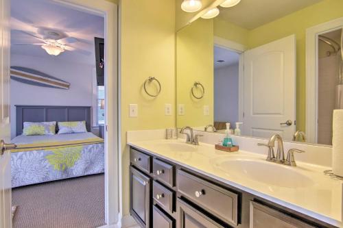 a bathroom with a sink and a mirror and a bed at 3 Mi to Fenwick Island Beach Luxe Bungalow in Peppers Landing