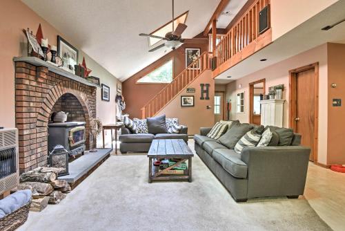 a living room with a couch and a fireplace at Peaceful Hamlin Home with Lake Access at The Hideout in Hamlin