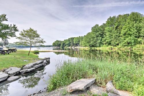 a view of a river with a picnic table at Peaceful Hamlin Home with Lake Access at The Hideout in Hamlin