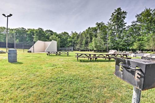 a group of picnic tables in a field at Peaceful Hamlin Home with Lake Access at The Hideout in Hamlin