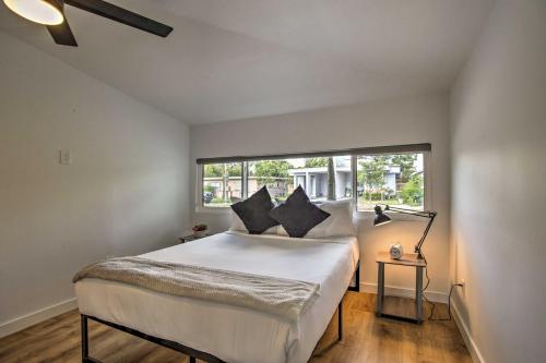 a bedroom with a large white bed with a window at Modern Home with Shared Pool in Fort Lauderdale! in Fort Lauderdale